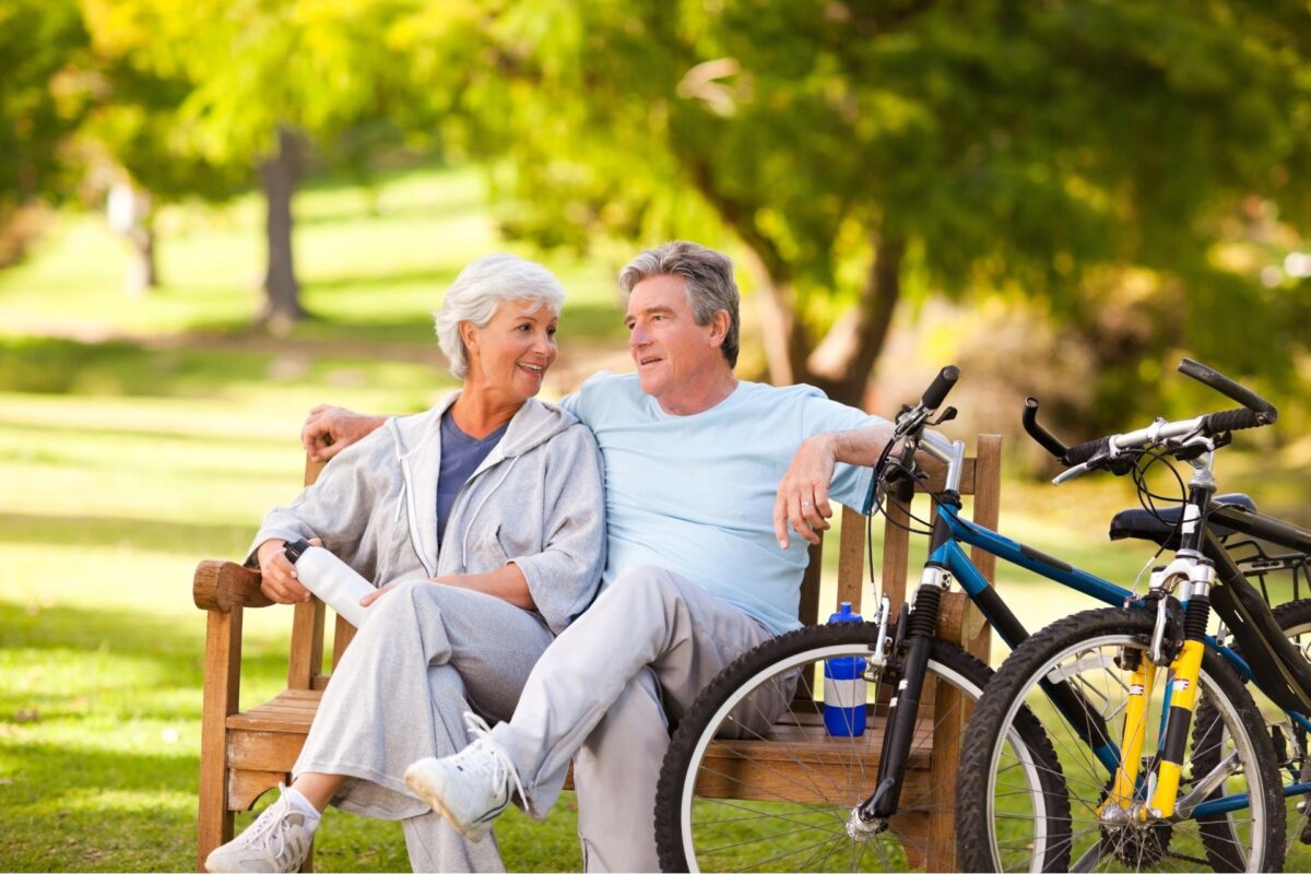 Elderly Couple in Crystal Lake, IL With Medigap Insurance, Relaxing on a Park Bench